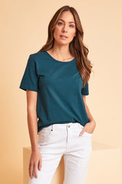 Model Madelinec wearing size 10 of the The Keepers Cotton Tee – Opal in colour Opal, in a cropped view