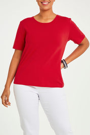 Model Noli wearing size 14 of The Keepers Tee in colour Red (Red), from the front, cropped image