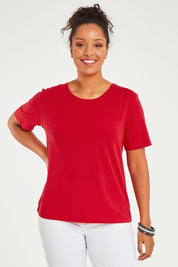 Model Noli wearing size 14 of The Keepers Tee in colour Red (Red), from the front, cropped image