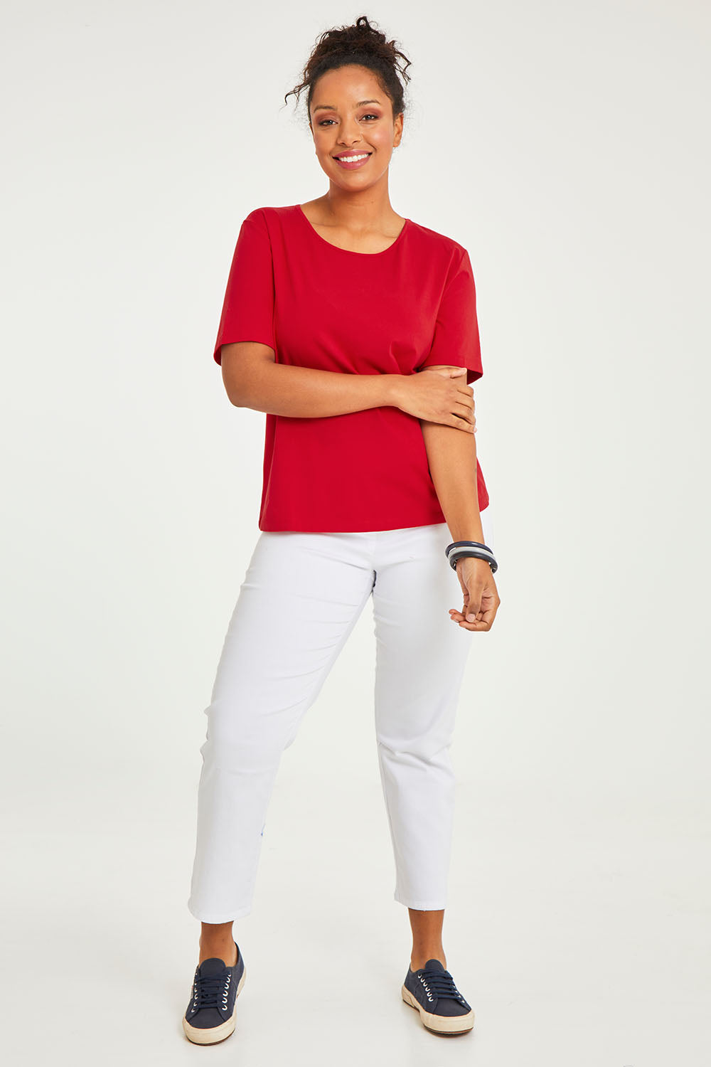 Model Noli wearing size 14 of The Keepers Tee in colour Red (Red), from the front, showing the whole outfit