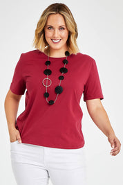 Model Jess wearing size 14 of The Keepers Tee in colour Rose (Pink), from the front, cropped image