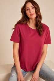 Model Madelinec wearing size 10 of the The Keepers Cotton Tee – Rose in colour Rose, in a cropped view