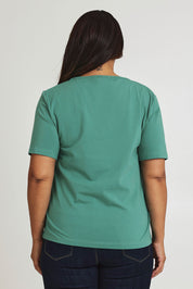 Model Ashleigh wearing size 16 of The Keepers Tee in colour Seagreen (Green), from the back