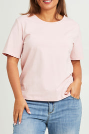 Model Monique wearing size 14 of The Keepers Tee in colour Softpink (Pink), from the front, cropped image
