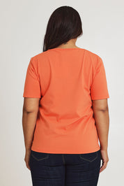 Model Ashleigh wearing size 16 of The Keepers Tee in colour Sunset, from the back