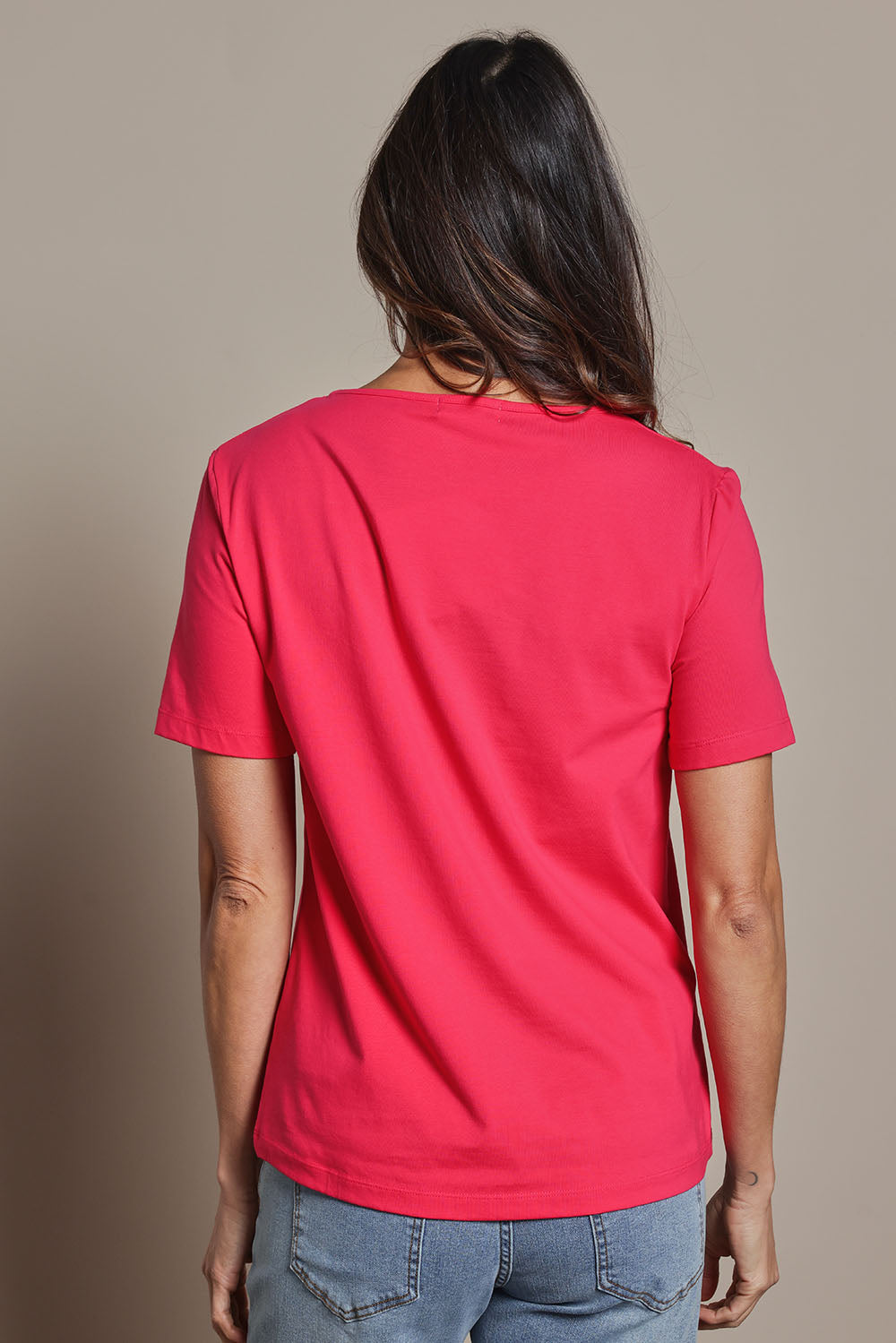 Model Amanda wearing size 10 of The Keepers Tee in colour Watermelon (Pink), from the back