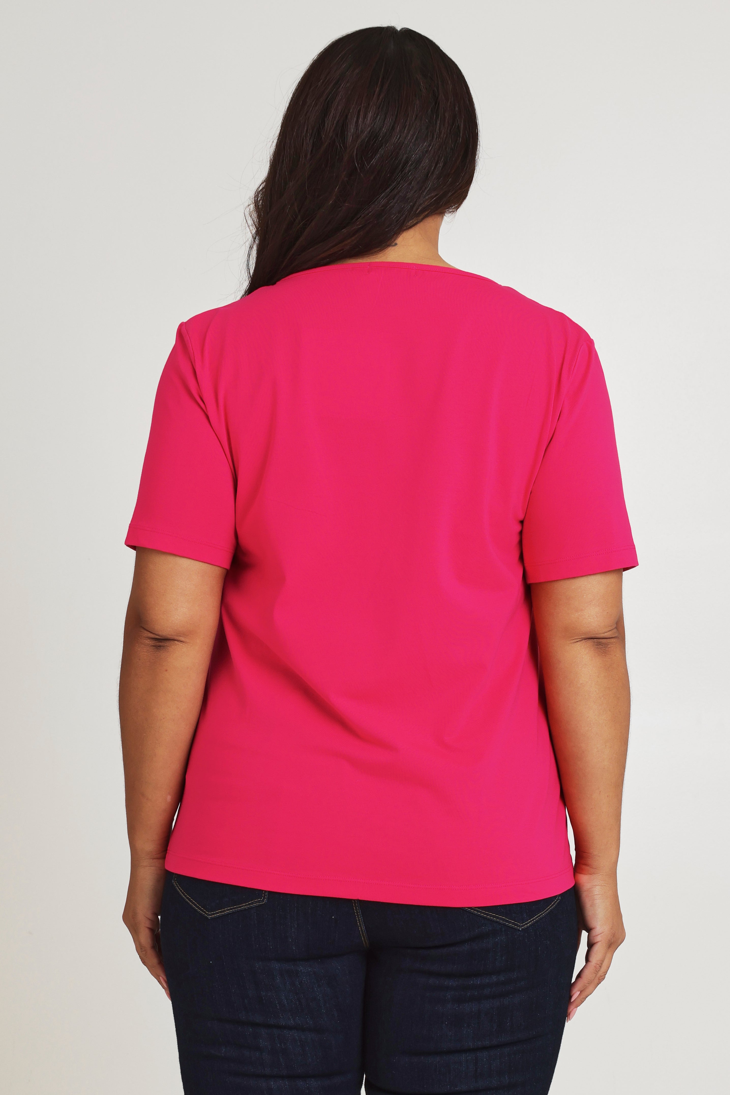 Model Ashleigh wearing size 16 of The Keepers Tee in colour Watermelon (Pink), from the back