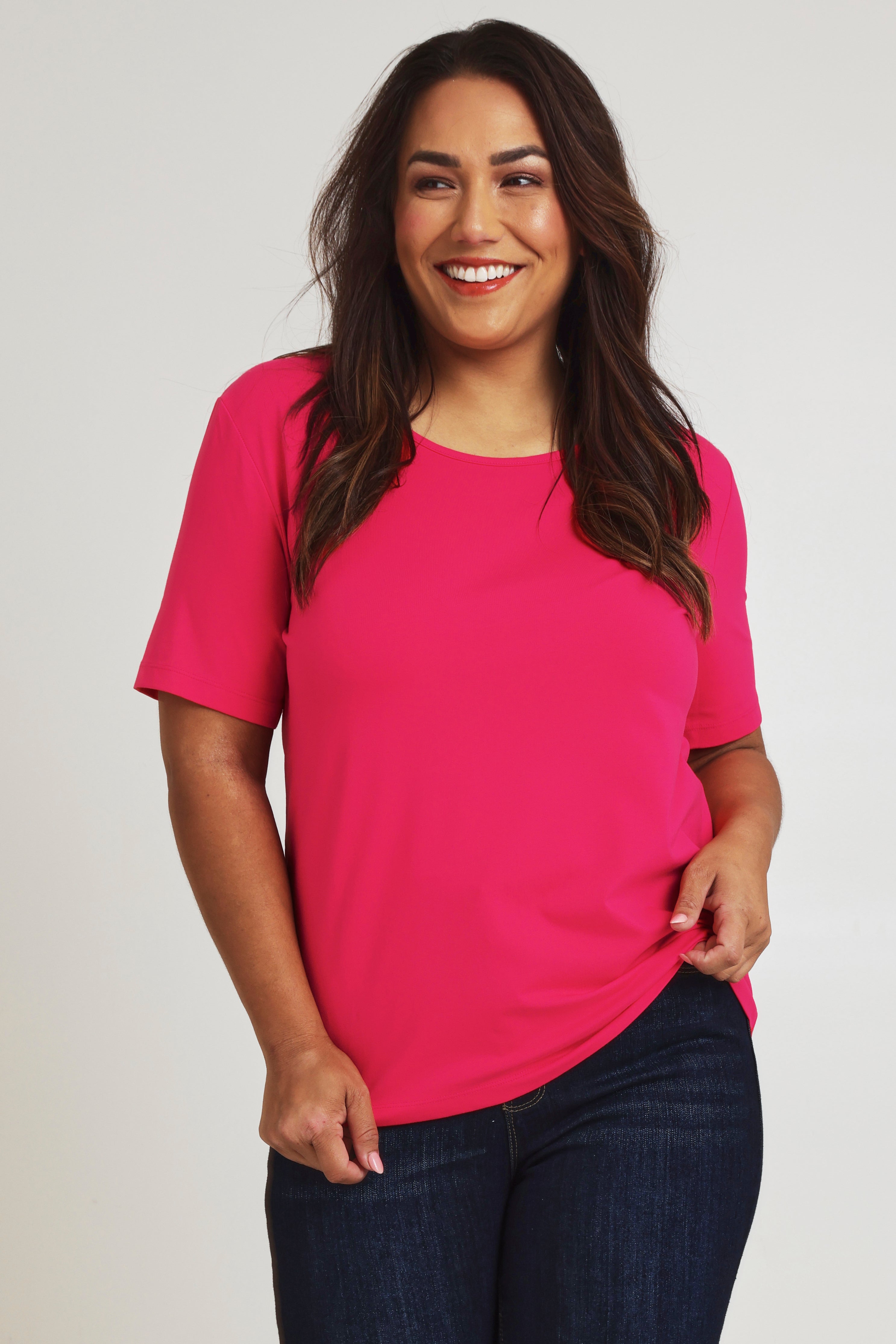 Model Ashleigh wearing size 16 of The Keepers Tee in colour Watermelon (Pink), from the front, cropped image