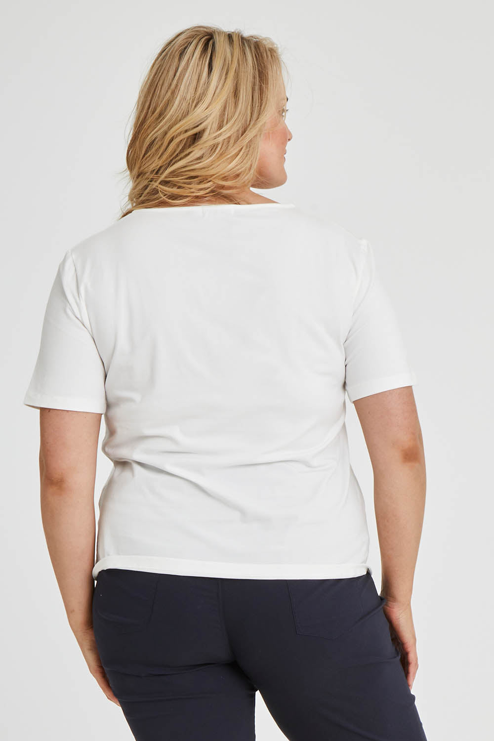 Model Keeara wearing size 16 of The Keepers Tee in colour White (White), from the back