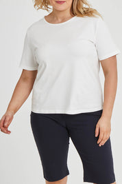 Model Keeara wearing size 16 of The Keepers Tee in colour White (White), from the front, cropped image