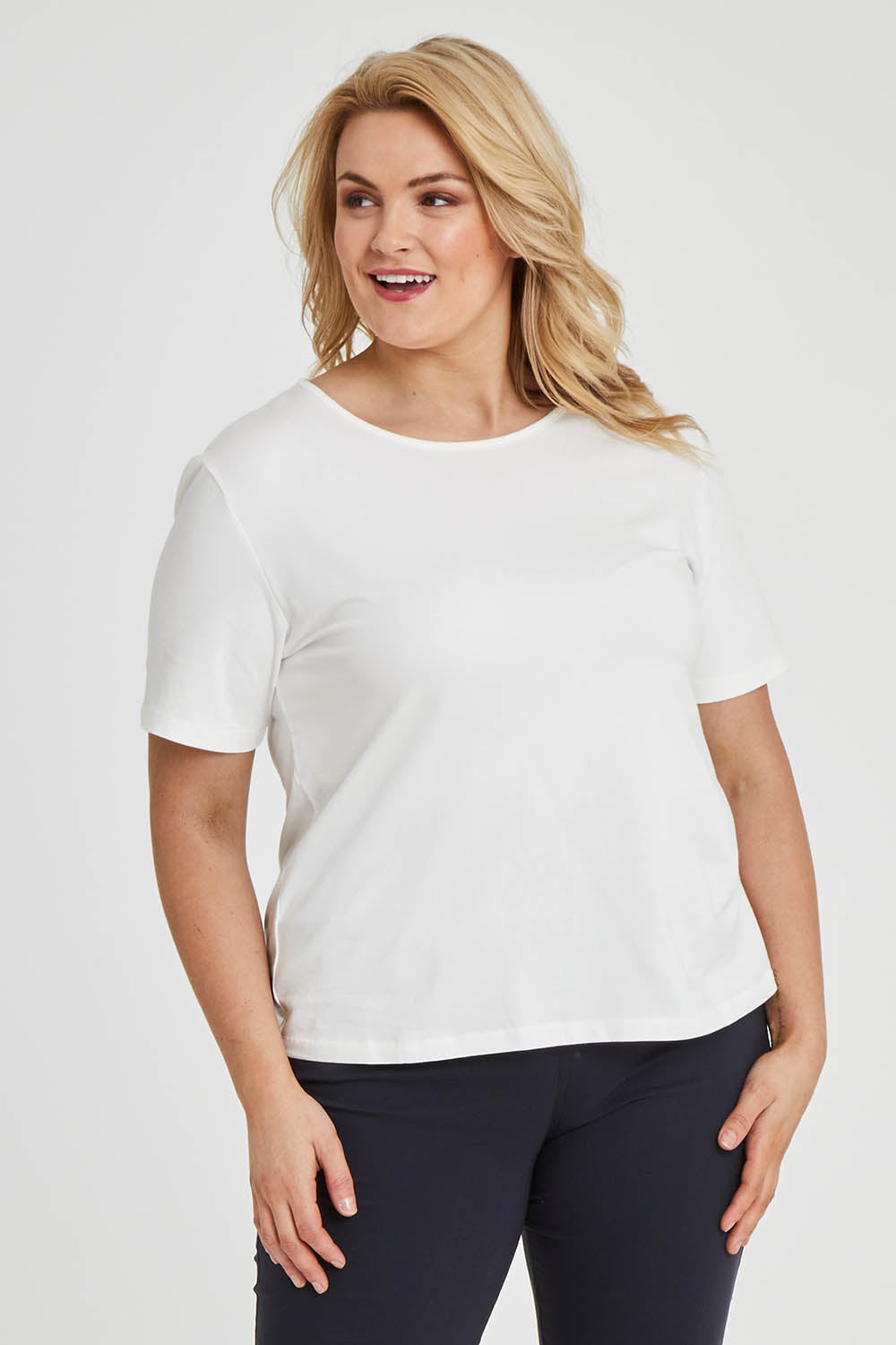 Model Keeara wearing size 16 of The Keepers Tee in colour White (White), from the front, cropped image