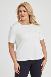 Model Keeara wearing size 16 of The Keepers Tee in colour White (White), from the front, cropped image