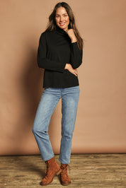 Model Madeline wearing size 10 of The Keepers Skivvy in colour Black (Black), from the front, showing the whole outfit