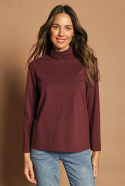Model Madeline wearing size 10 of The Keepers Skivvy in colour Burgundy (Purple), from the front, cropped image