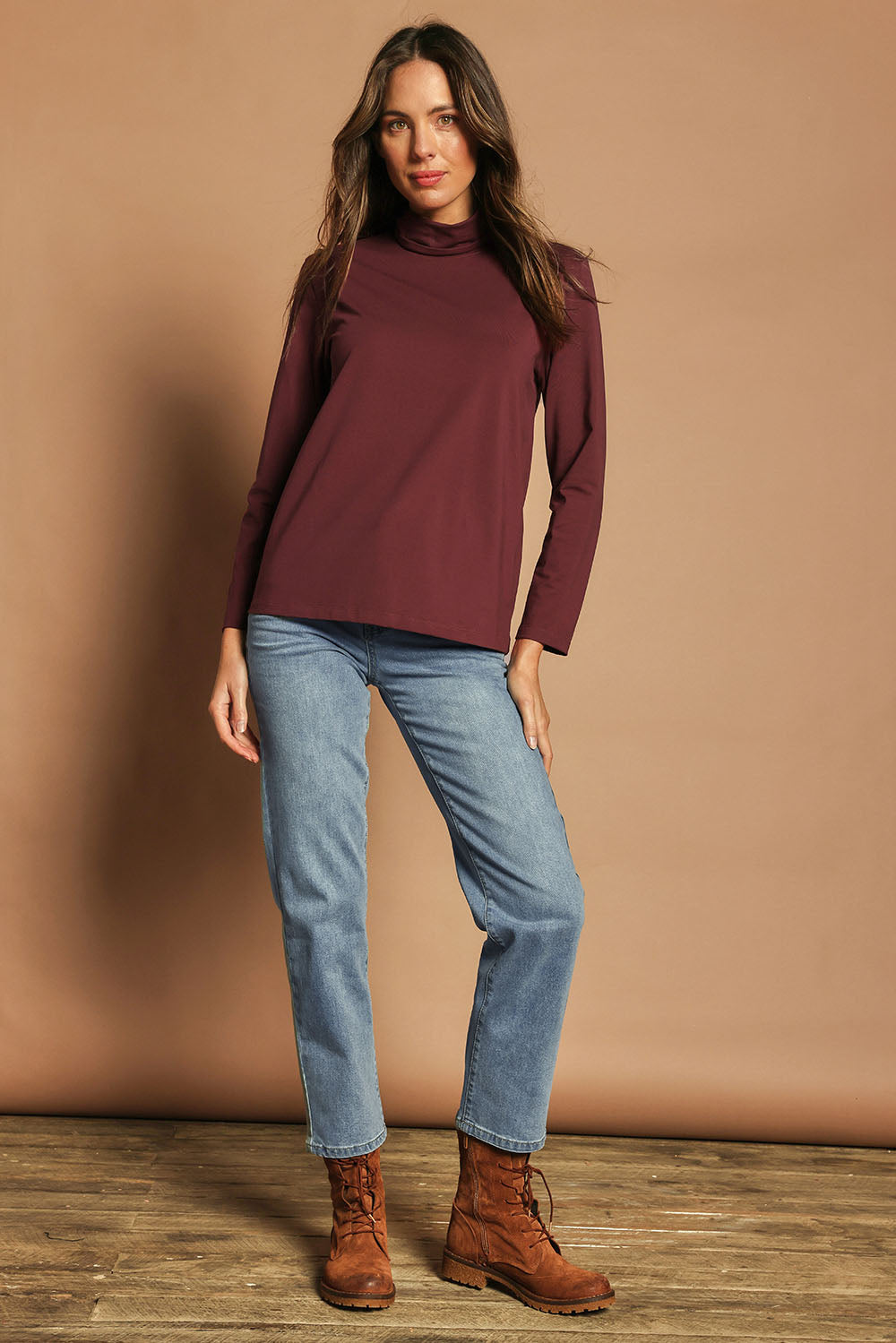 Model Madeline wearing size 10 of The Keepers Skivvy in colour Burgundy (Purple), from the front, showing the whole outfit