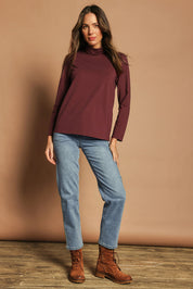 Model Madeline wearing size 10 of The Keepers Skivvy in colour Burgundy (Purple), from the front, showing the whole outfit