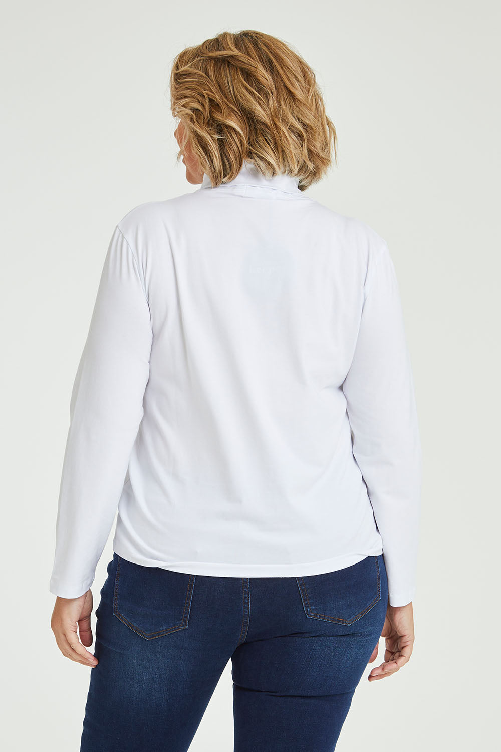 Model Fiona wearing size 16 of The Keepers Skivvy in colour White (White), from the back