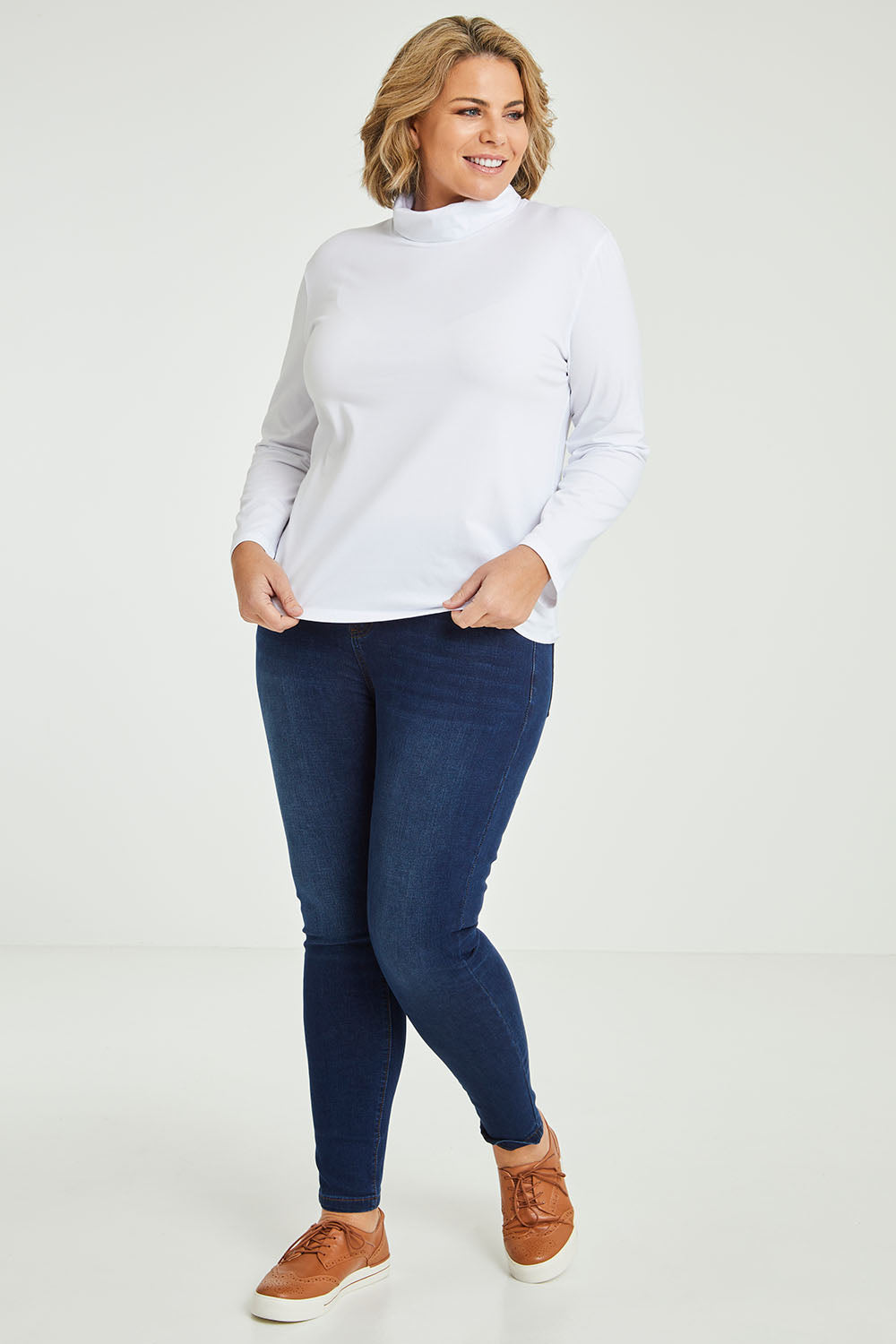 Model Fiona wearing size 16 of The Keepers Skivvy in colour White (White), from the front, showing the whole outfit