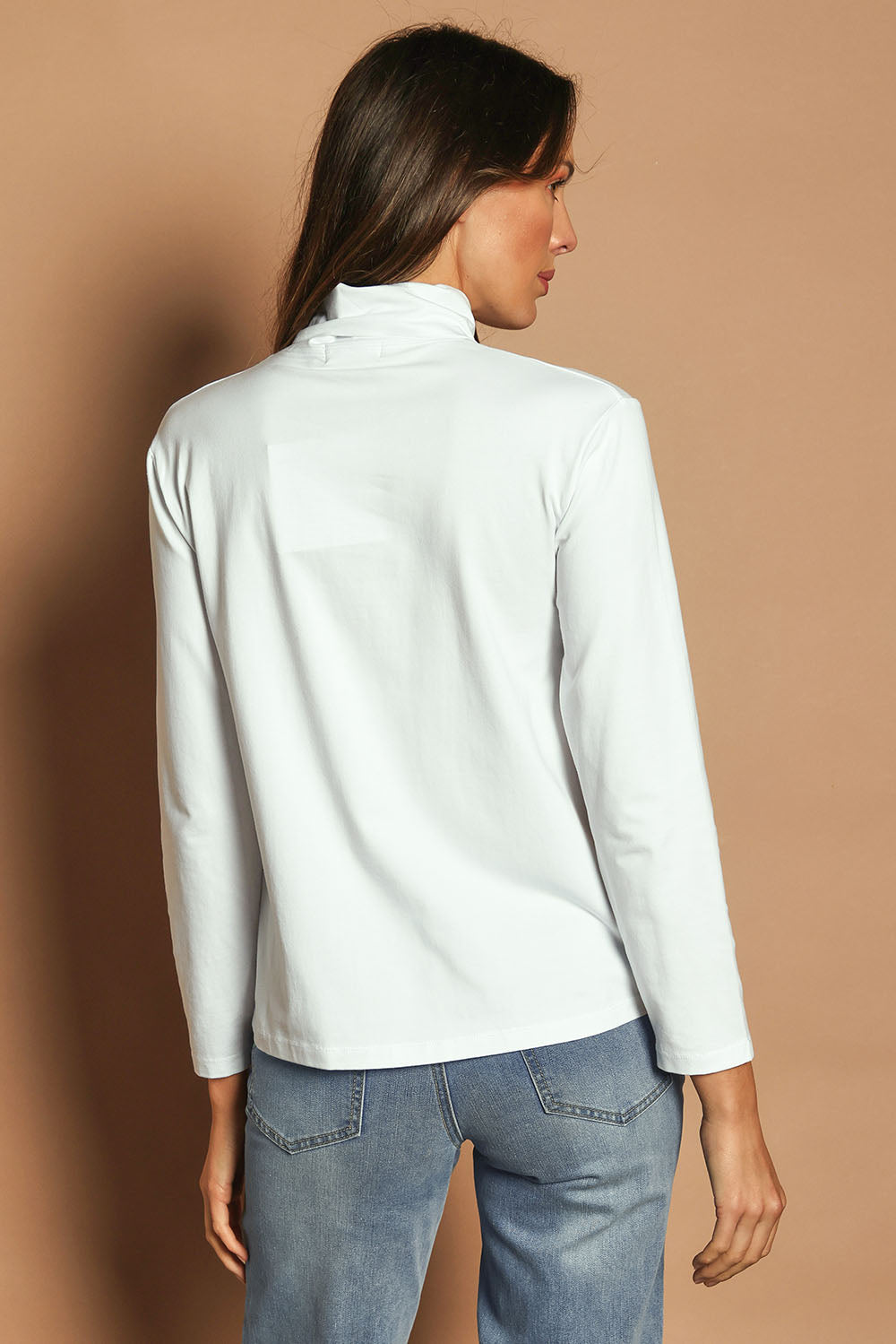 Model Madeline wearing size 10 of The Keepers Skivvy in colour White (White), from the back