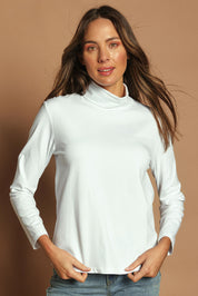 Model Madeline wearing size 10 of The Keepers Skivvy in colour White (White), from the front, showing the whole outfit
