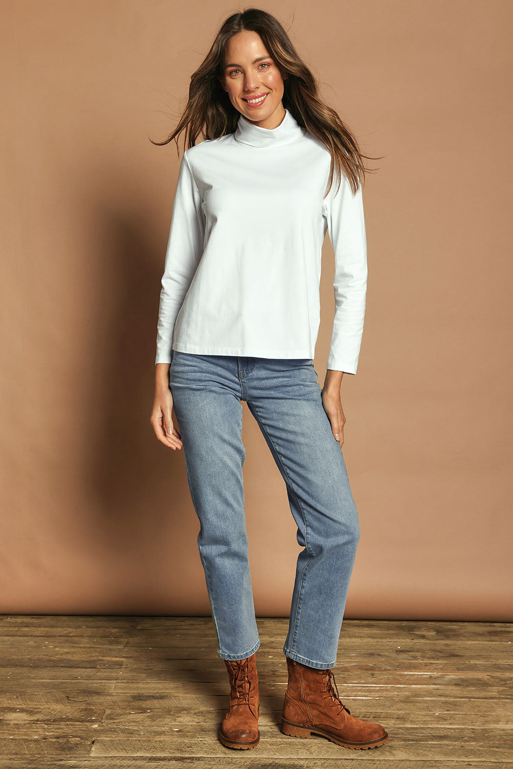 Model Madeline wearing size 10 of The Keepers Skivvy in colour White (White), from the front, showing the whole outfit