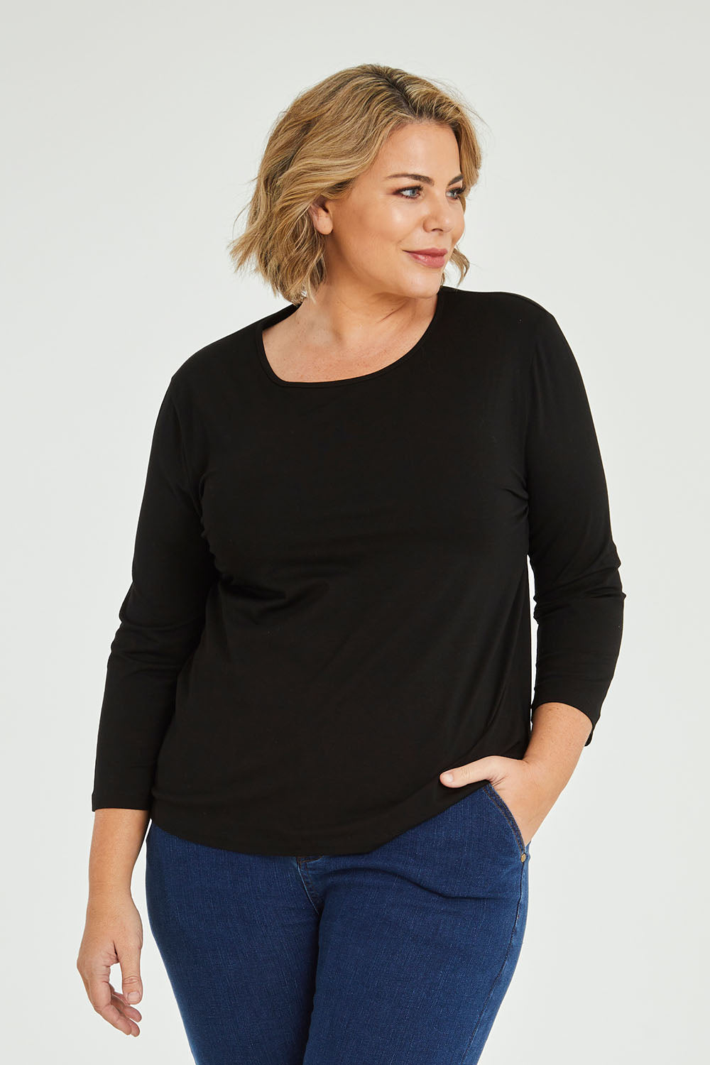 Model Fiona wearing size 16 of The Keepers 3/4 Sleeve Tee in colour Black (Black), from the front, cropped image