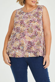 Model Fiona wearing size 16 of The Woven Swing Tank in colour Multispot (White), from the front, cropped image