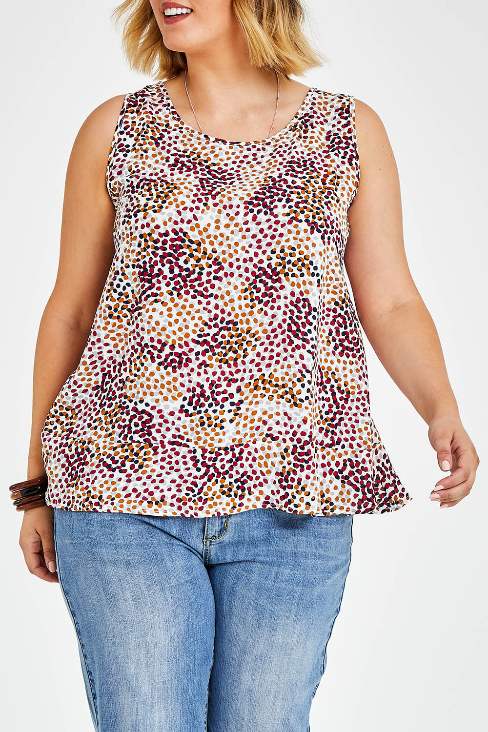 Model Jess wearing size 14 of The Woven Swing Tank in colour Multispot (White), from the front, cropped image