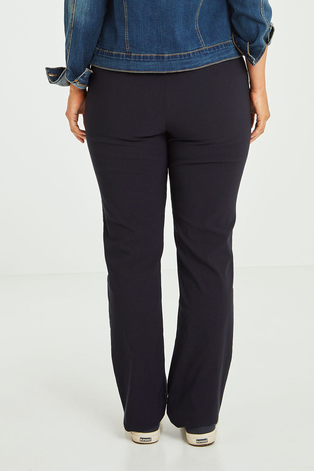 Model Laura wearing size 14 of The Bengaline Everyday Pant in colour Navy (Blue), from the back