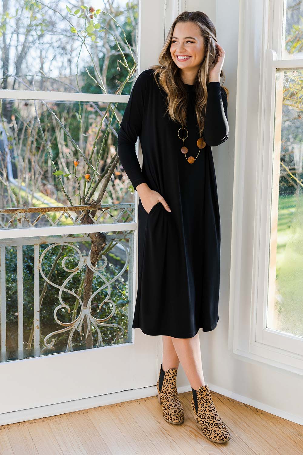 Model Tahlia wearing size 10 of The Recycled Long Sleeve Everyday Dress in colour Black (Black), from the front, showing the whole outfit