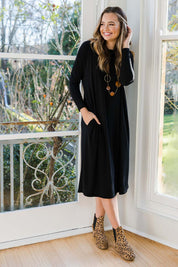 Model Tahlia wearing size 10 of The Recycled Long Sleeve Everyday Dress in colour Black (Black), from the front, showing the whole outfit