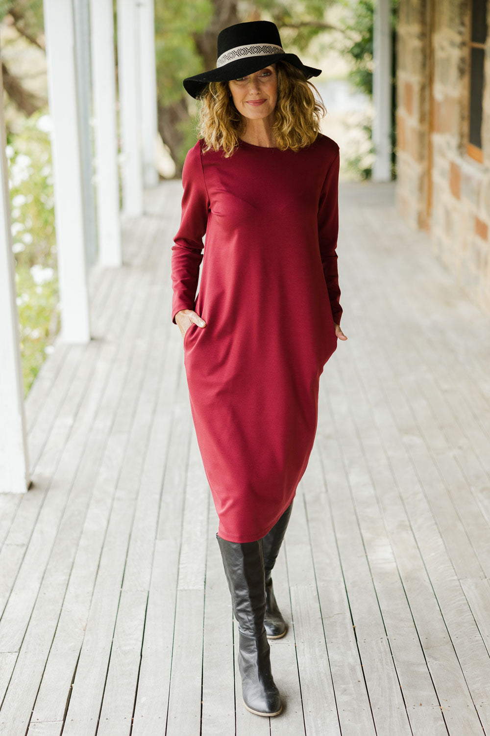 Model Emma wearing size 10 of The Dropped Shoulder Ponte Dress in colour Pomegranat (Red), from the front, showing the whole outfit