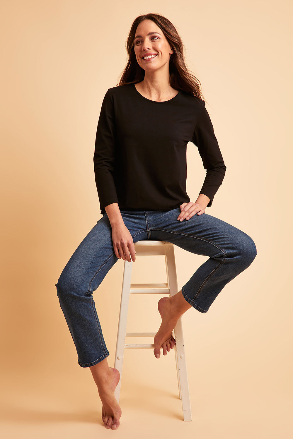 Model Madeline wearing size 10 of The Keepers Long Sleeve Tee in colour Black (Black), from the front, showing the whole outfit