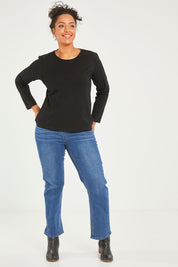 Model Noli wearing size 16 of The Keepers Long Sleeve Tee in colour Black (Black), from the front, showing the whole outfit