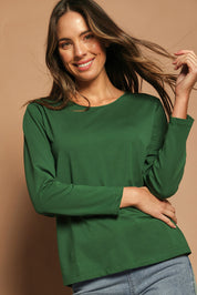Model Madeline wearing size 10 of The Keepers Long Sleeve Tee in colour Forest (Green), from the front, cropped image