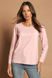 Model Madeline wearing size 10 of The Keepers Long Sleeve Tee in colour Softpink (Pink), from the front, cropped image