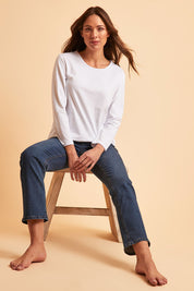 Model Madeline wearing size 10 of The Keepers Long Sleeve Tee in colour White (White), from the front, showing the whole outfit