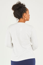 Model Noli wearing size 14 of The Keepers Long Sleeve Tee in colour White (White), from the back