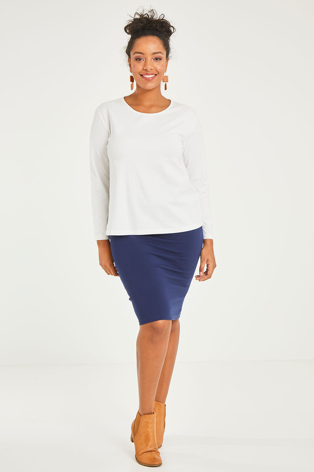 Model Noli wearing size 14 of The Keepers Long Sleeve Tee in colour White (White), from the front, showing the whole outfit