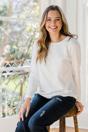 Model Tahlia wearing size 10 of The Keepers Long Sleeve Tee in colour White (White), from the front, showing the whole outfit