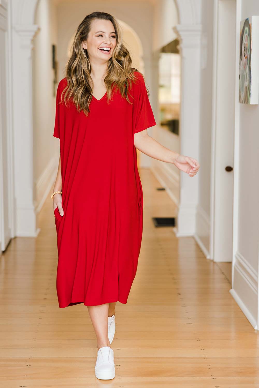 Model Tahlia wearing size 10 of The Recycled Everyday V Neck Dress in colour Cherryred (Red), from the front, showing the whole outfit