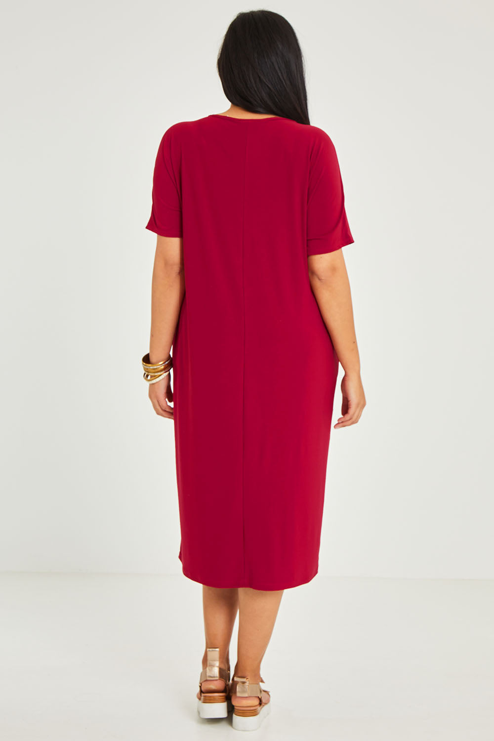 Model Terri-Leigh wearing size 14 of The Recycled Everyday V Neck Dress in colour Cherryred (Red), from the back