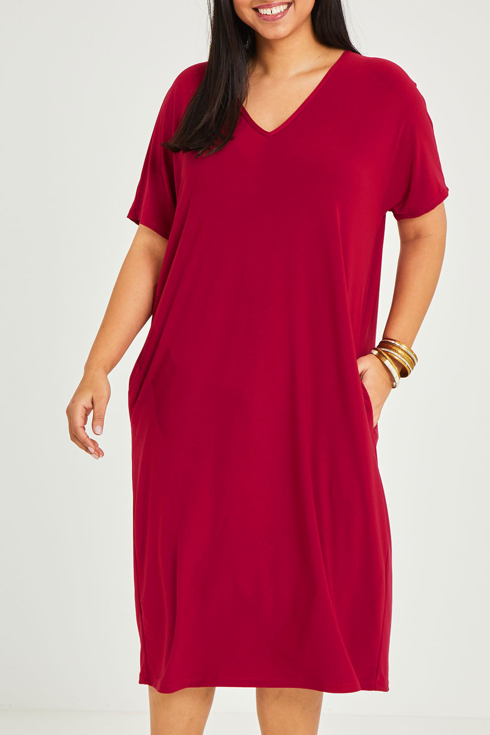 Model Terri-Leigh wearing size 14 of The Recycled Everyday V Neck Dress in colour Cherryred (Red), from the front, cropped image