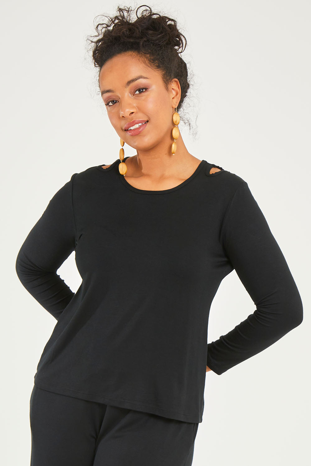 Model Noli wearing size 14 of The Cut Out Jersey Top in colour Black (Black), from the front, cropped image