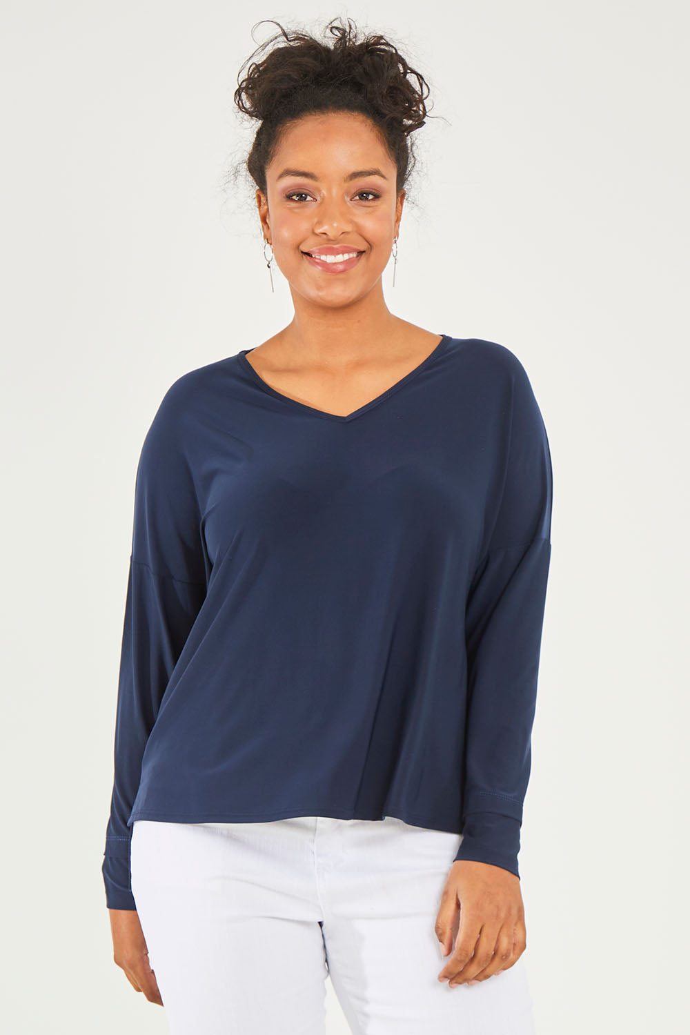 Model Noli wearing size 14 of The Recycled V Neck Double Cuff Top in colour Navy (Blue), from the front, cropped image