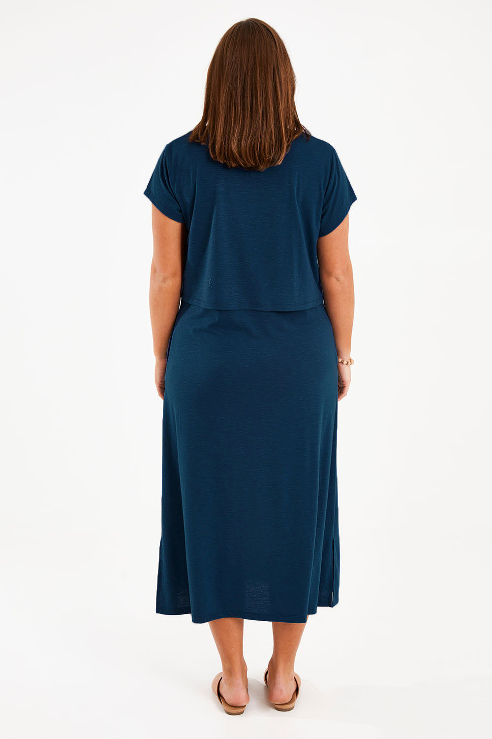 Model Monique wearing size 14 of The Layered Tee Dress in colour Blueocean (Blue), from the back