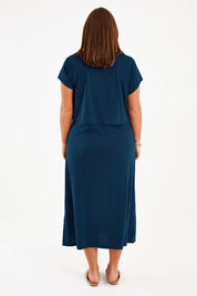 Model Monique wearing size 14 of The Layered Tee Dress in colour Blueocean (Blue), from the back