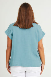 Model Monique wearing size 14 of The Textured Easy Wear Tank in colour Chambray (Blue), from the back