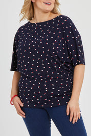 Model Keeara wearing size 16 of The Printed Wide Basque Top in colour Navyspot (Blue), from the front, cropped image