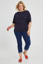 Model Keeara wearing size 16 of The Printed Wide Basque Top in colour Navyspot (Blue), from the front, showing the whole outfit